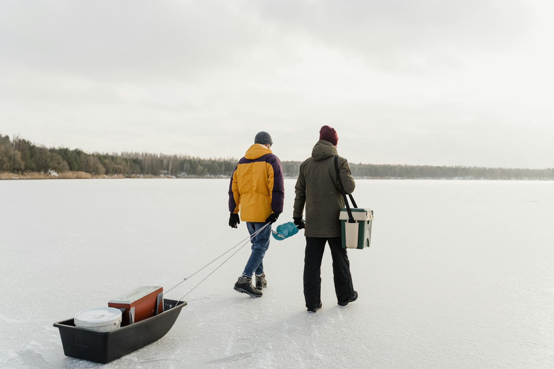 Angler dragging an ice fishing sled