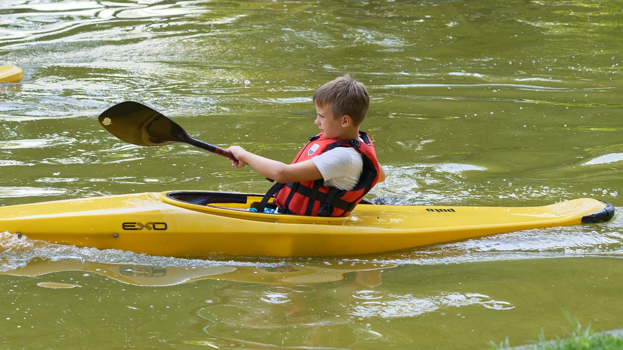 a kid kayaking in water